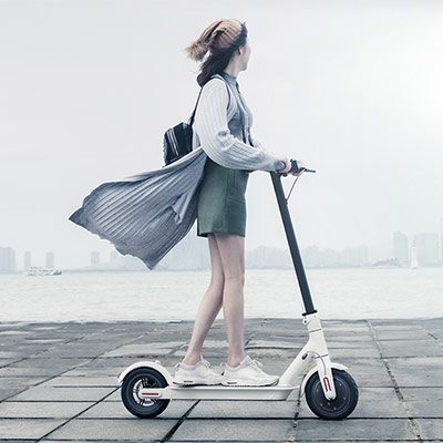 Lady riding Xiaomi MiJia Electric Folding Scooter